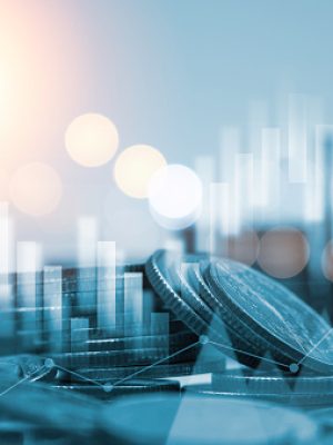 Blue double exposure of money coins stacking with bar graph for financial and investment business concept.